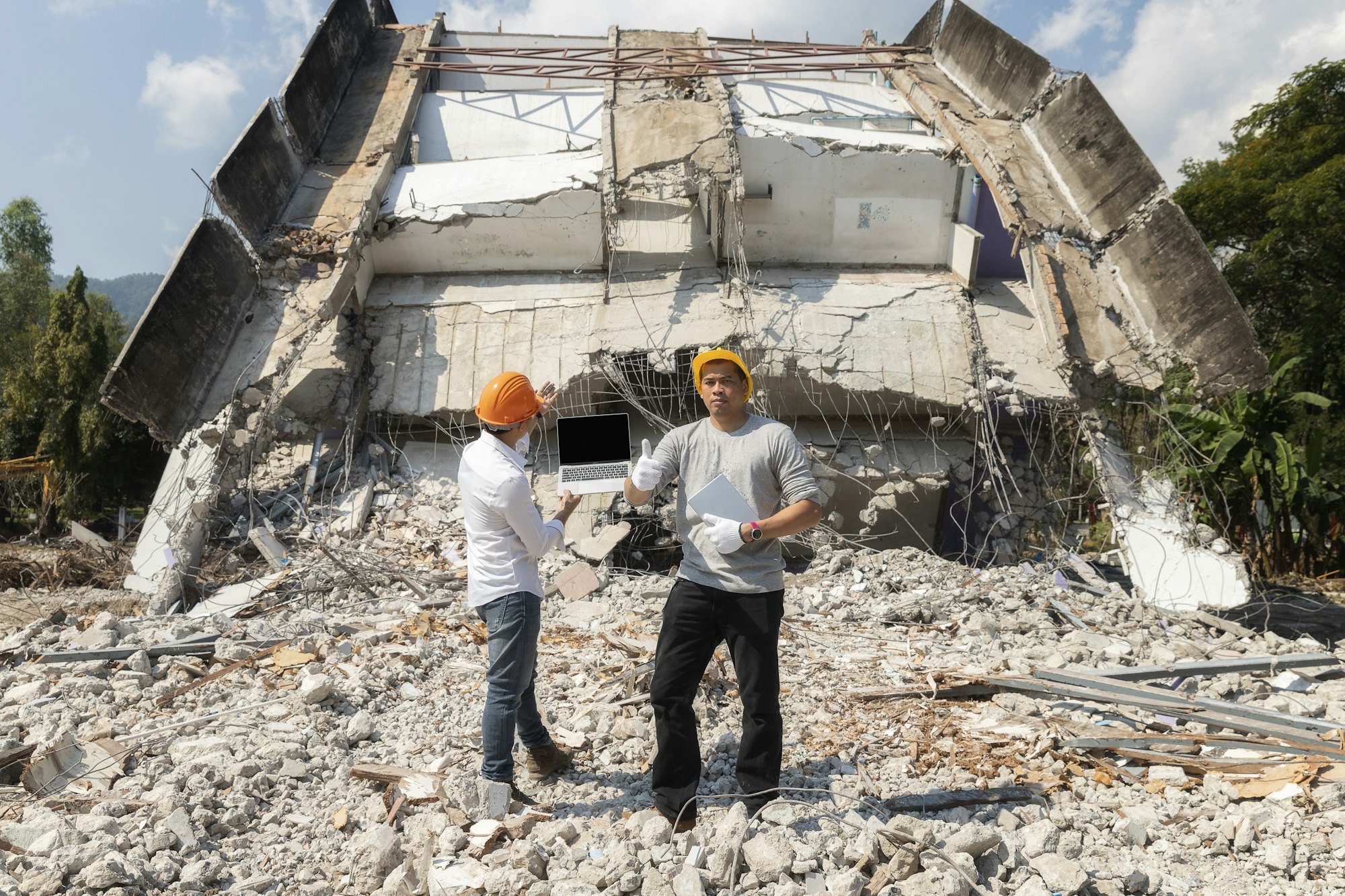 Demolition control supervisor or foreman thumbs up on demolish building.